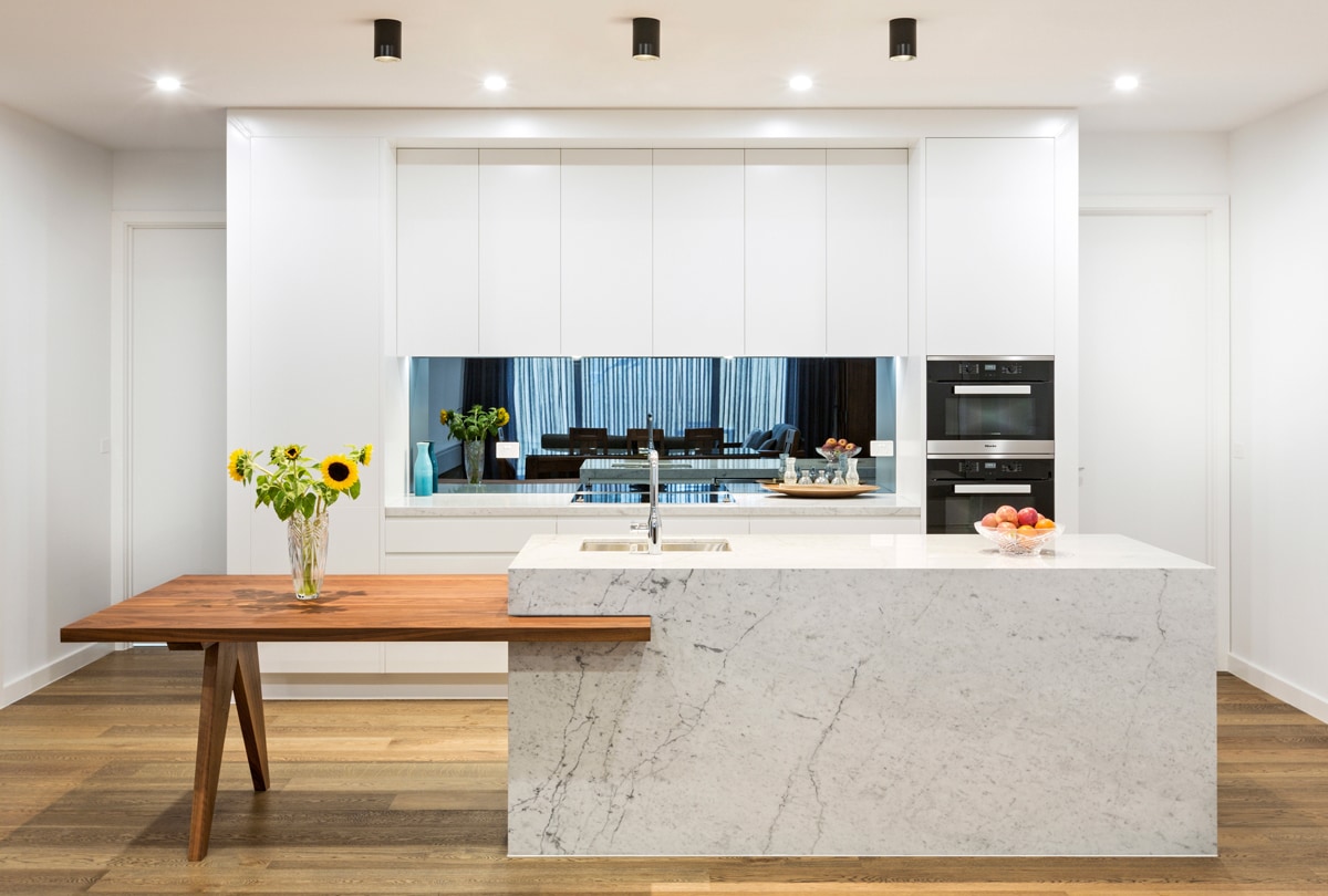 modern-white-kitchen-with-marble-benchtop-and-walnut-timber-table