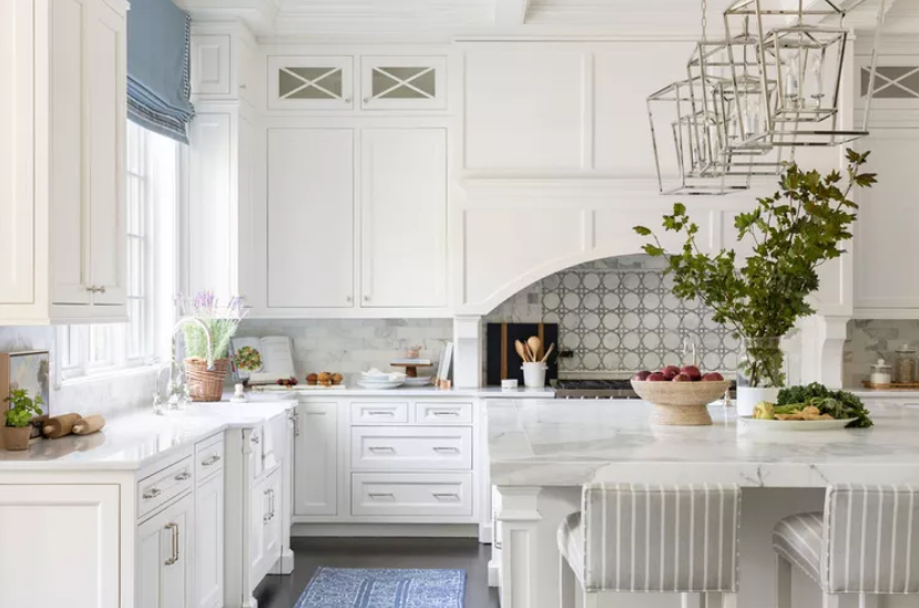 Traditional white kitchen with detailed cabinetry, marble benchtops and large island